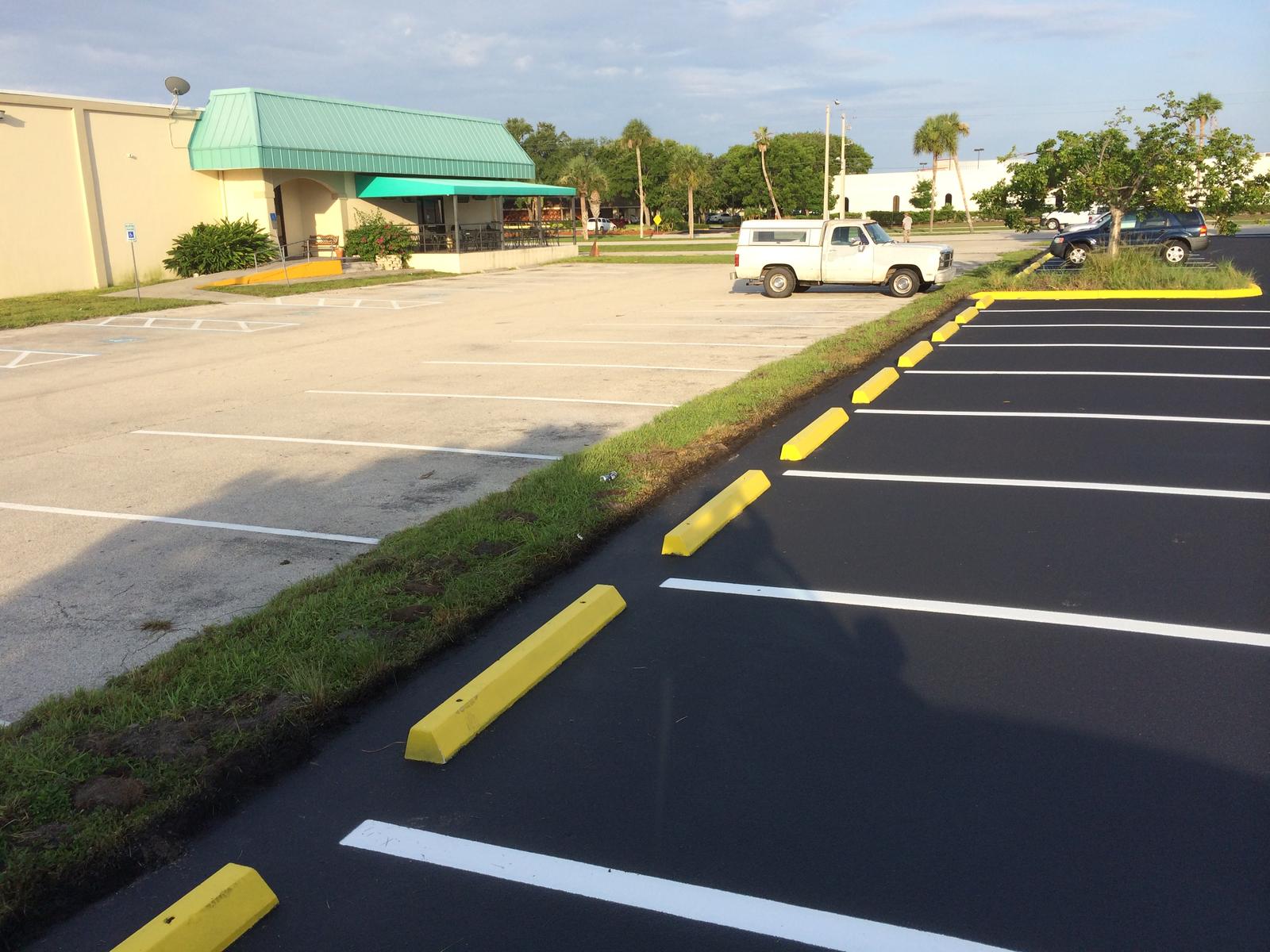 Yellow wheel stops along a newly striped row